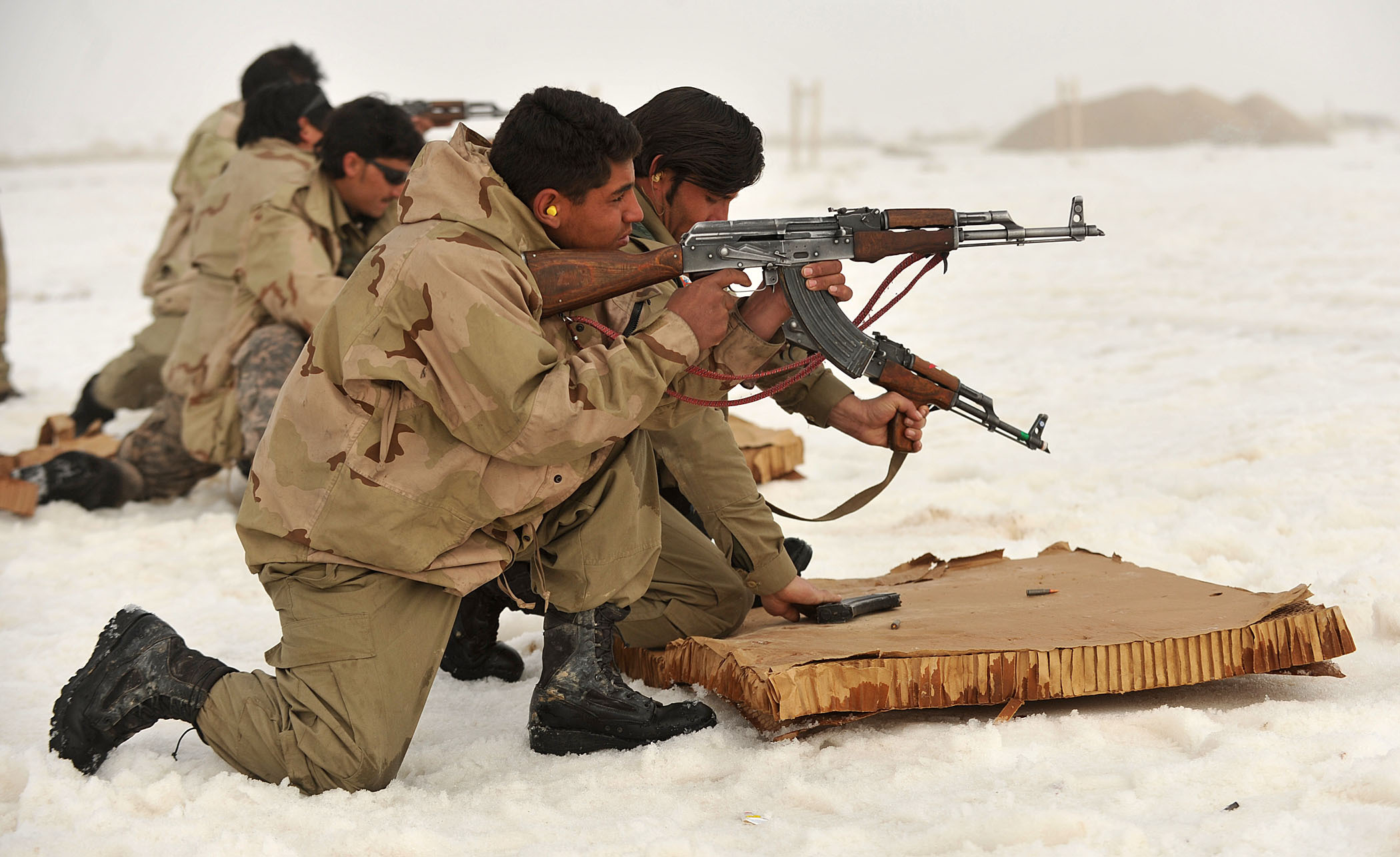 Members of the Afghan National Police and Afghan Local Police fire their AK-47 rifles from the kneeling position during weapons training in Nawbahar district, Zabul province, Afghanistan, March 1. The ANP and ALP work with other Afghan National Security Forces to provide security and stability in the district.